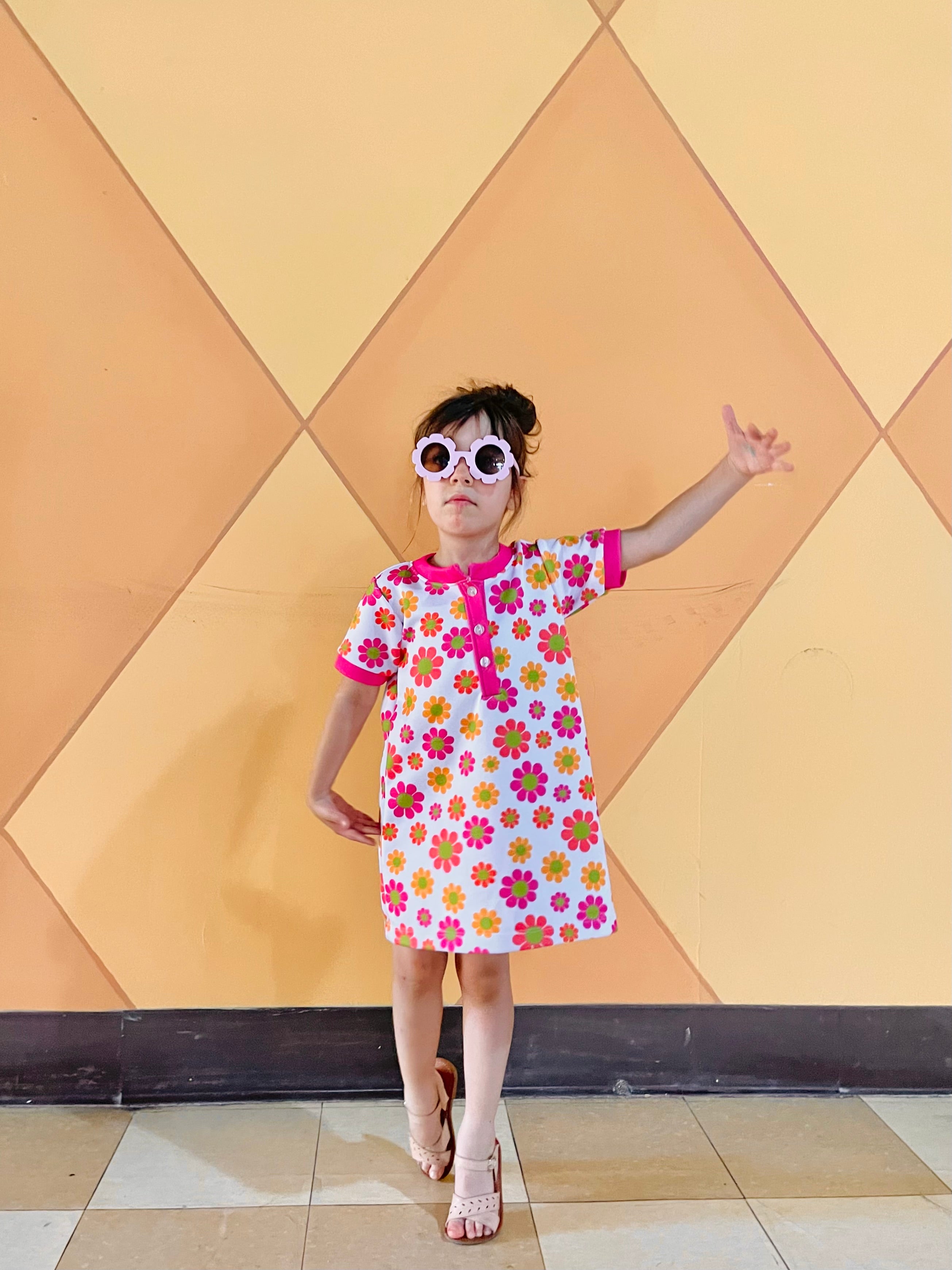 girl wearing 60s vintage toddler flower dress