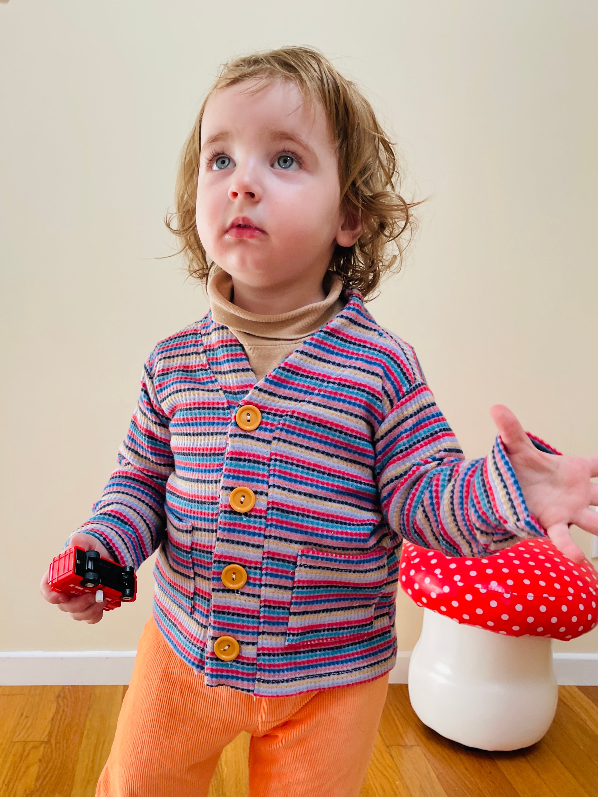 cute toddler boy wearing 80s vintage cardigan