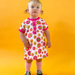 toddler girl wearing 60s flower power print dress