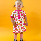 toddler girl wearing 60s flower power print dress