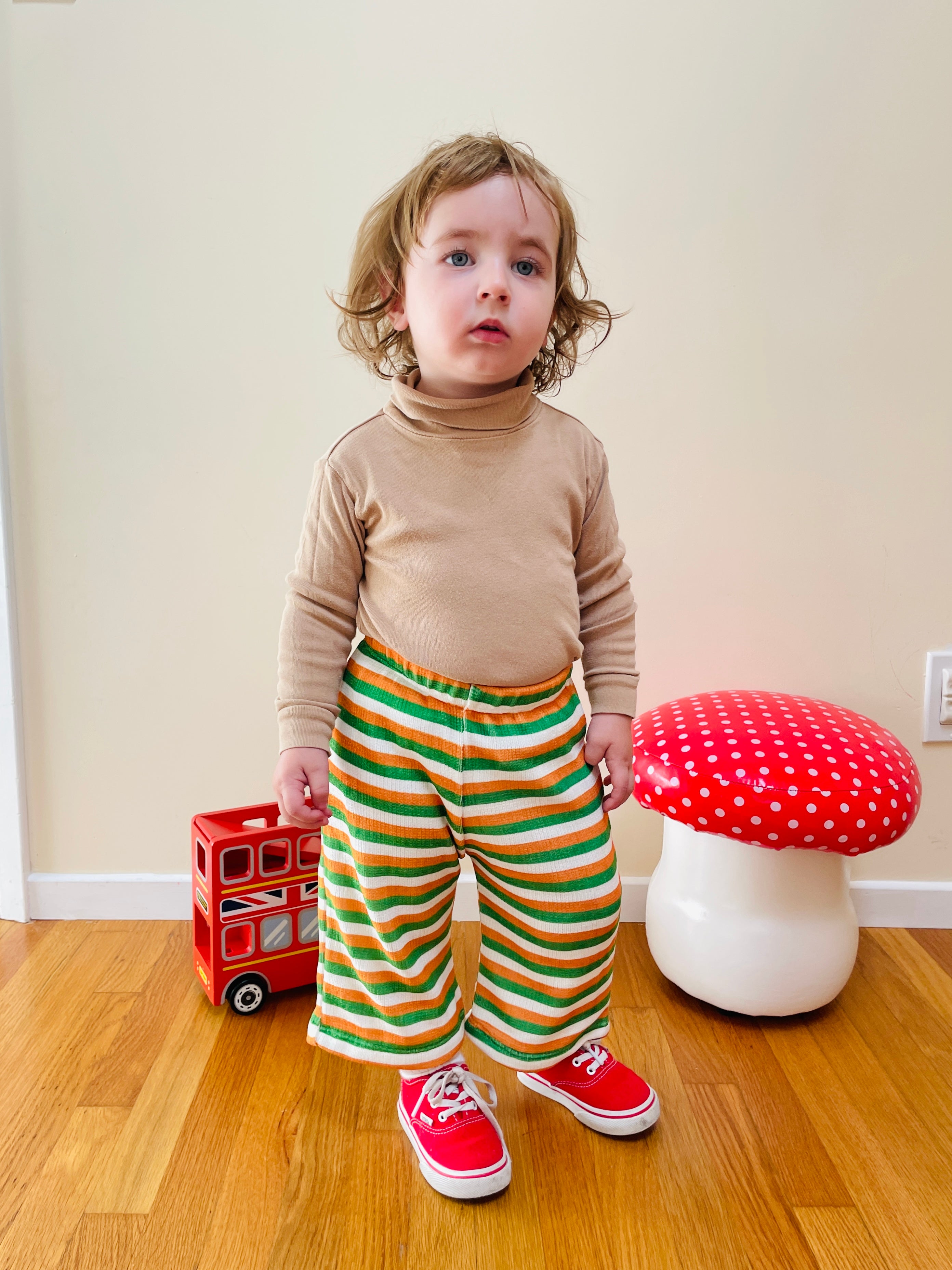 cute toddler boy wearing retro outfit and vintage wide leg pants