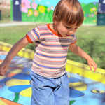 cute toddler boy wearing retro ringer tee on colorful playground