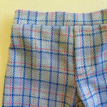 close up of kids plaid vintage style pants on yellow background 