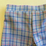 close up of kids plaid vintage style pants on yellow background 