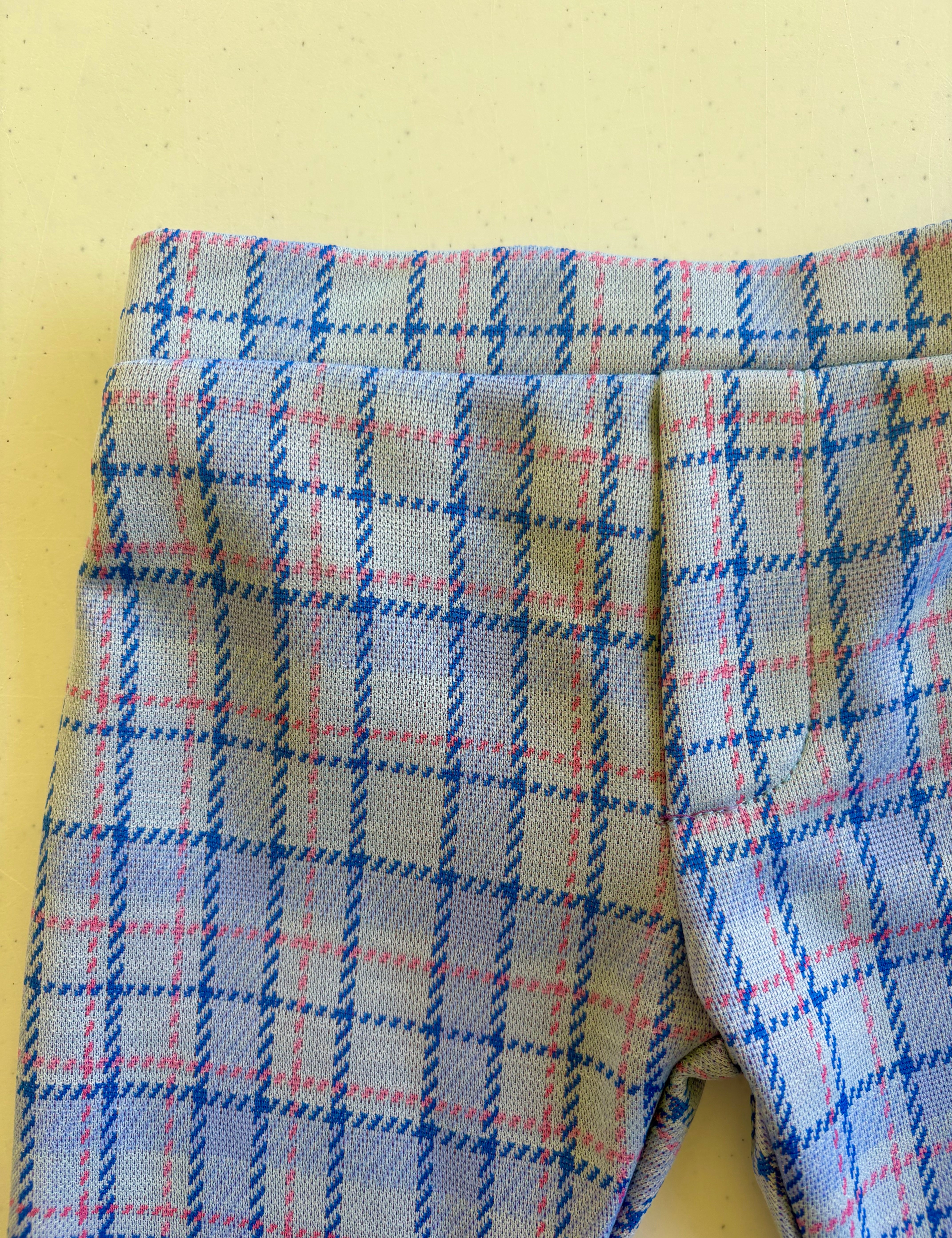 close up of kids plaid vintage style pants on yellow background 