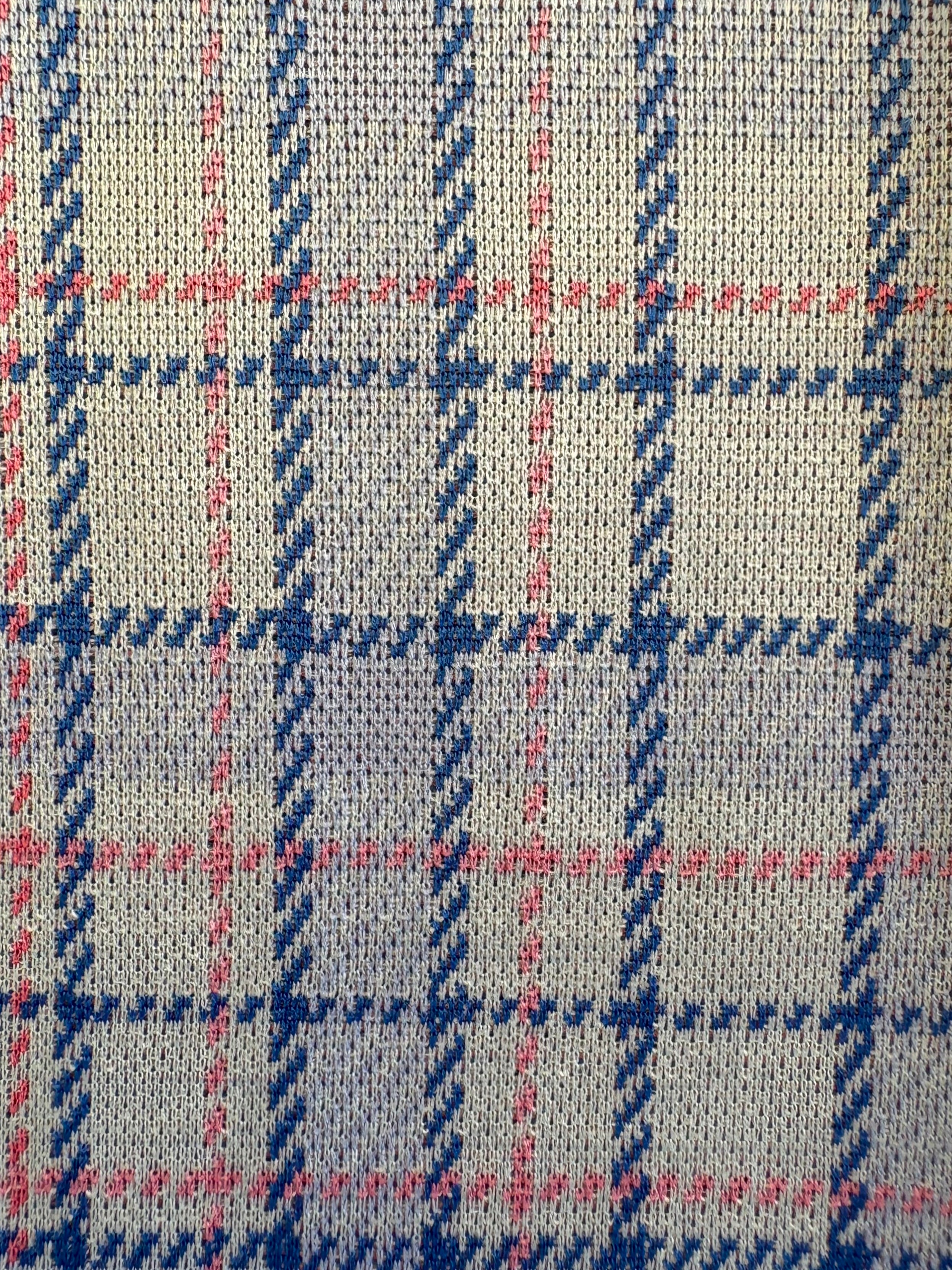 Close-up of fabric with blue and pink plaid pattern