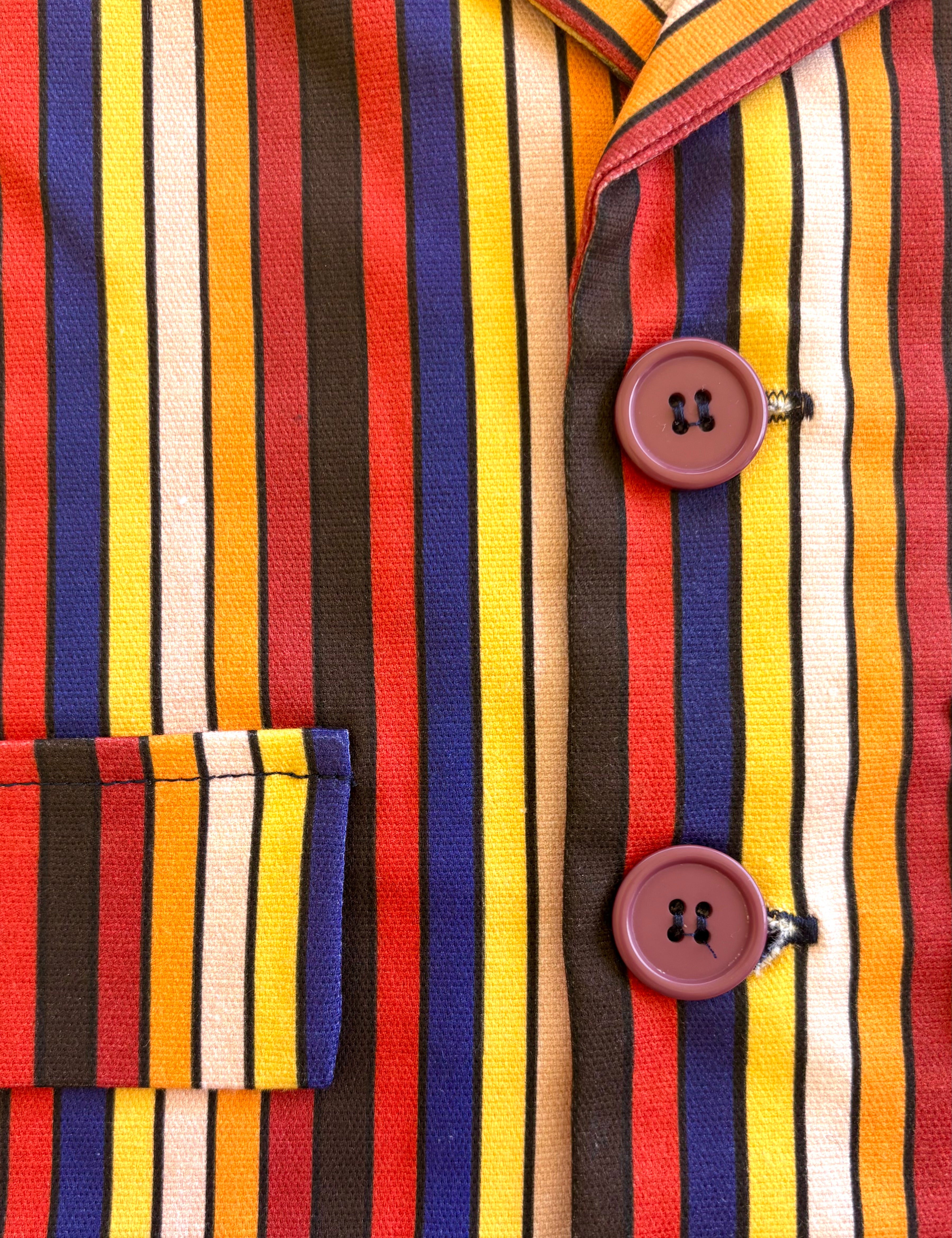 Close-up of a colorful children boys toddler kids striped shirt with buttons