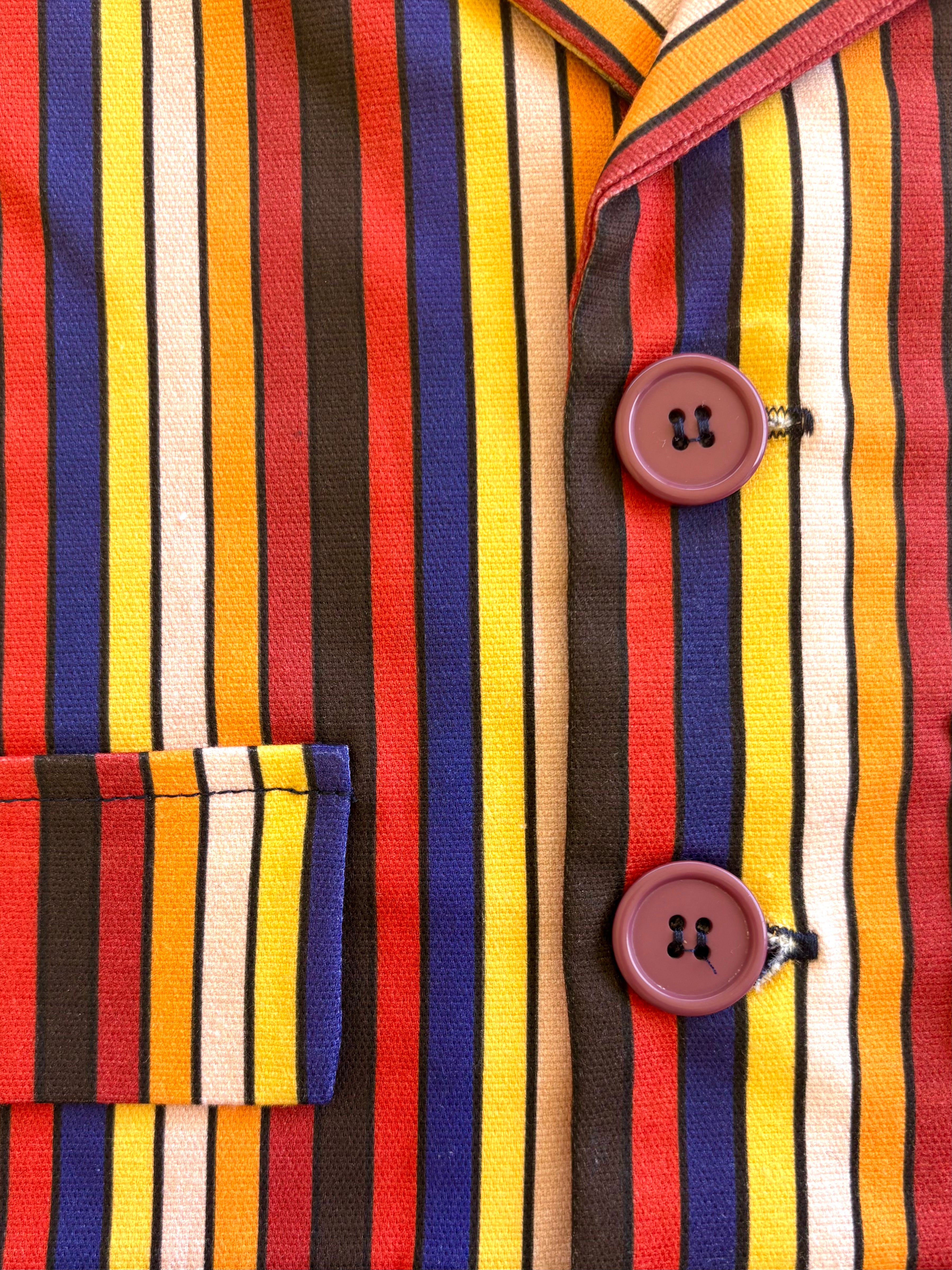 Close-up of a colorful children boys toddler kids striped shirt with buttons