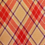Close-up of a patterned fabric with red, beige, and purple colors.