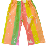 Colorful children's pants with bird design on a light green background