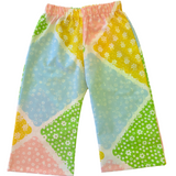 Colorful patterned toddler kids pants on a light background