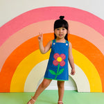 toddler girl wearing groovy vintage dress with daisy 