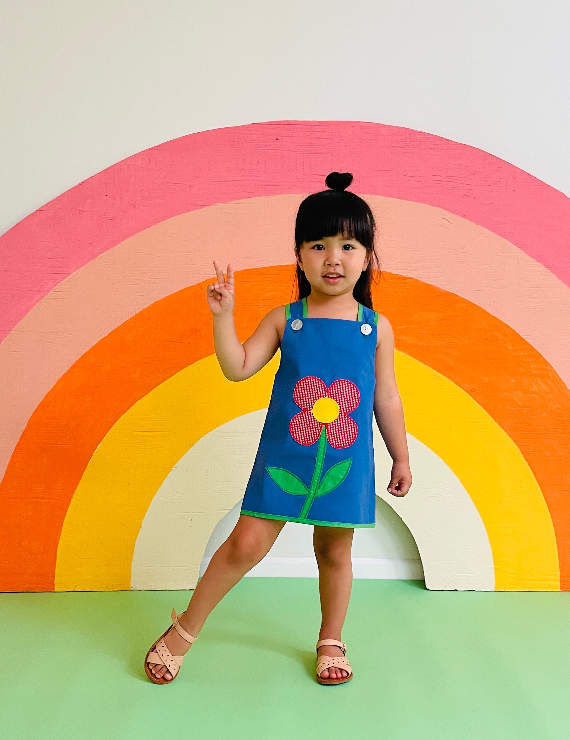 toddler girl wearing groovy vintage dress with daisy 
