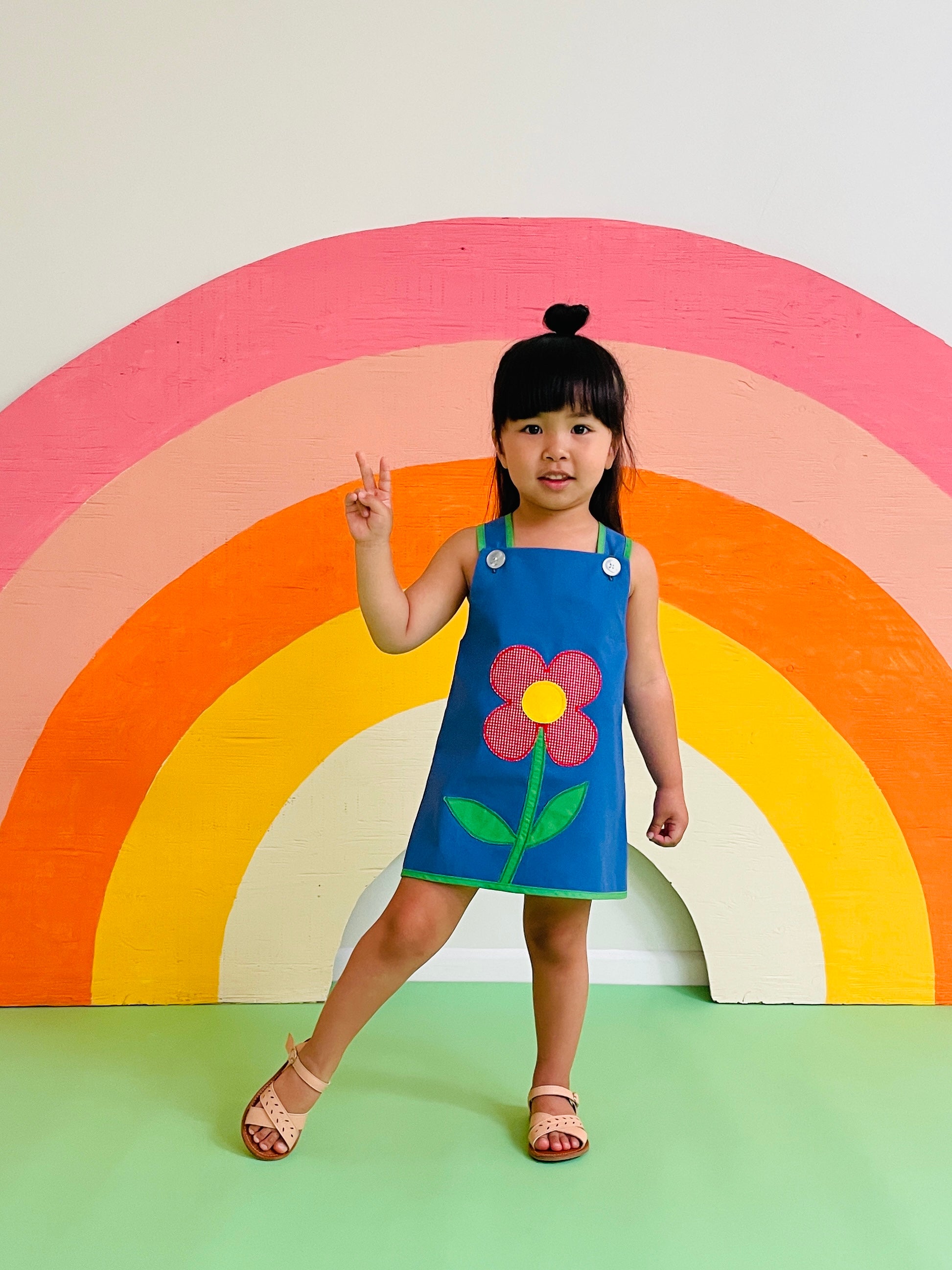 toddler girl wearing groovy vintage dress with daisy 
