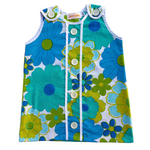 girls 70s style flower power dress with blue and green flowers on a white background