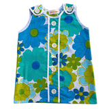 girls 70s style flower power dress with blue and green flowers on a white background