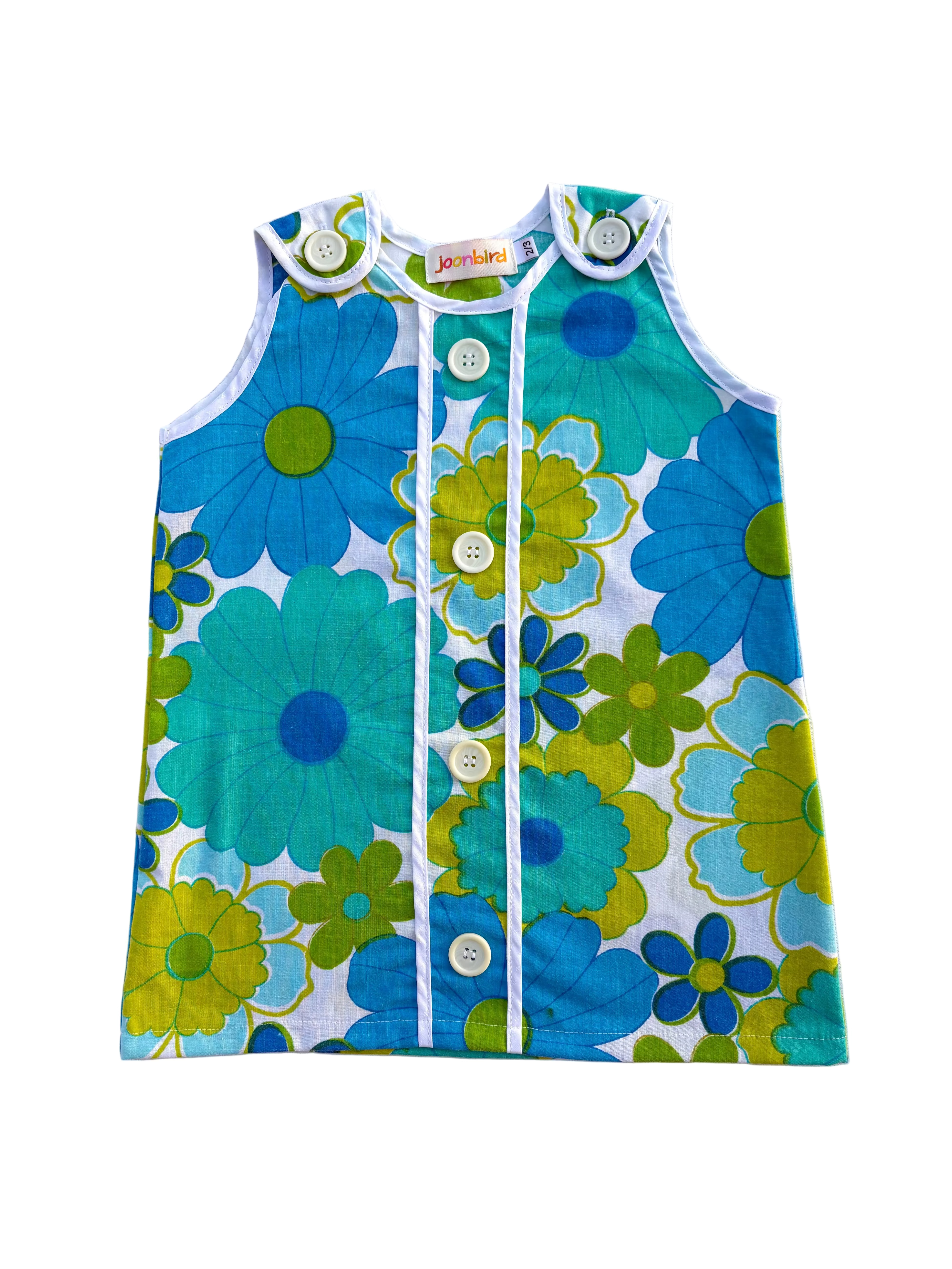 girls 70s style flower power dress with blue and green flowers on a white background
