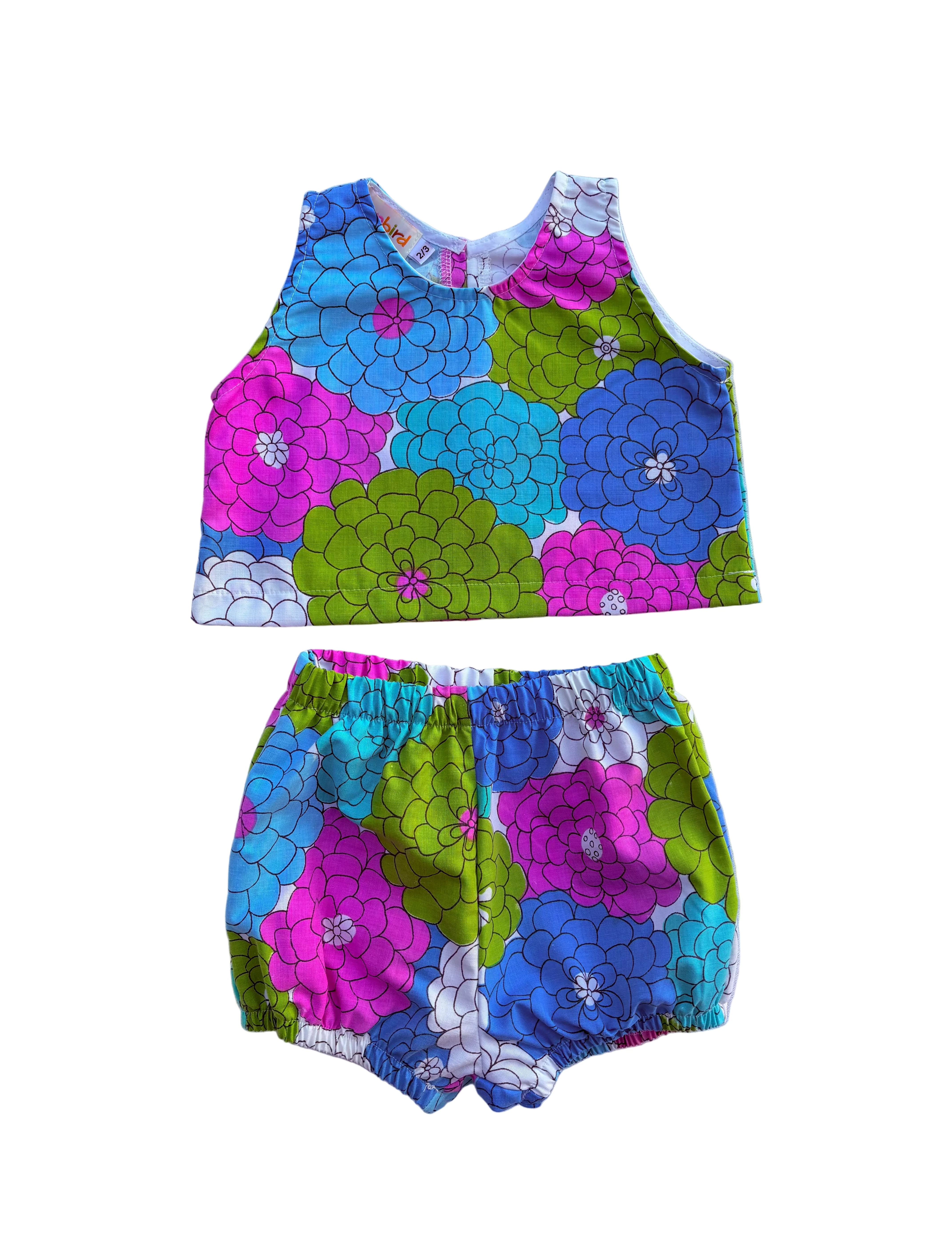 girls colorful floral summer outfit set with blue purple and green flowers on a white background 