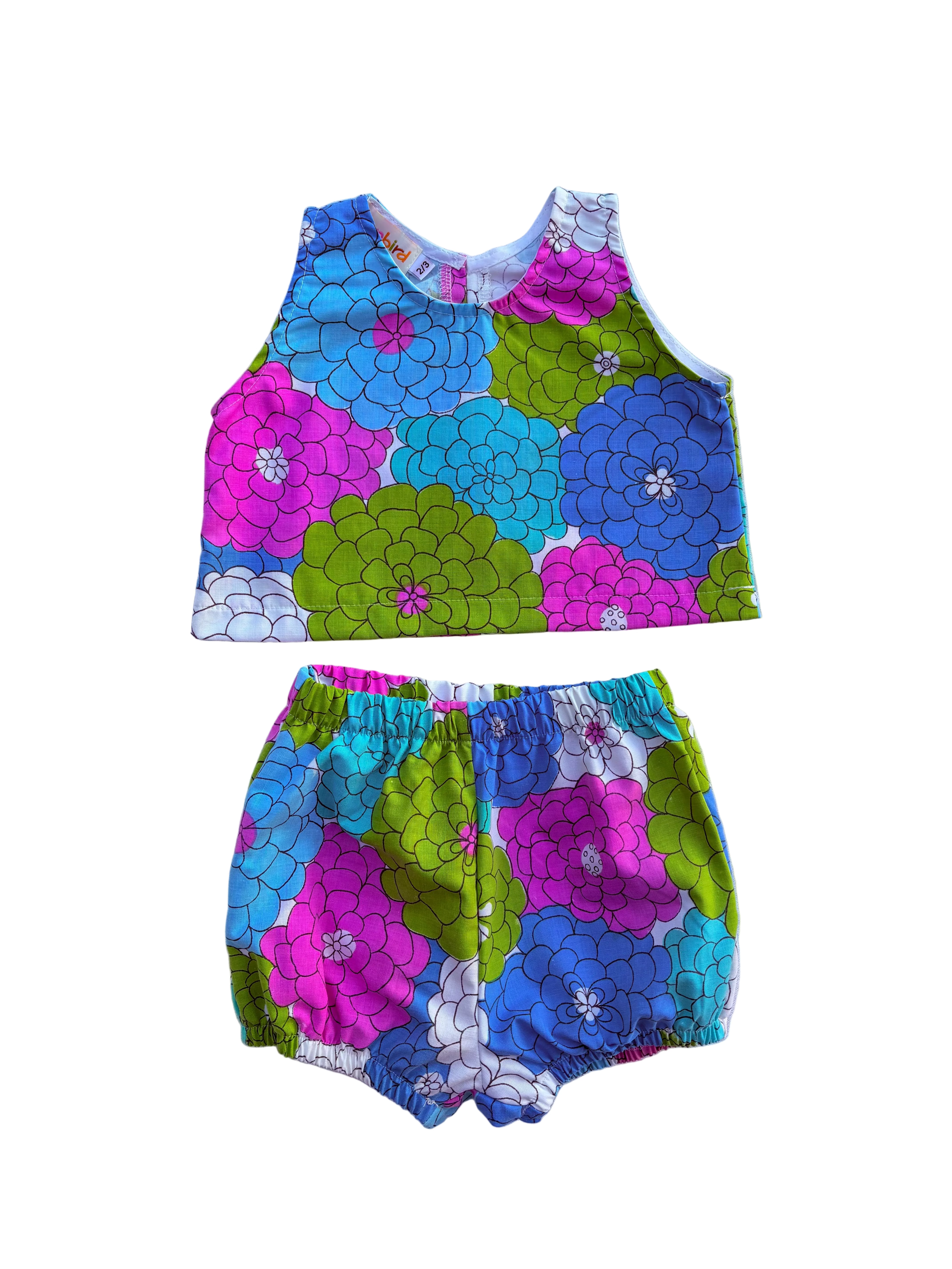girls colorful floral summer outfit set with blue purple and green flowers on a white background 