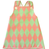 Mint and pink vintage style adorable harlequin-patterned dress with pink and green diamonds on a white background