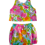 Colorful girls floral top and shorts set on a white background