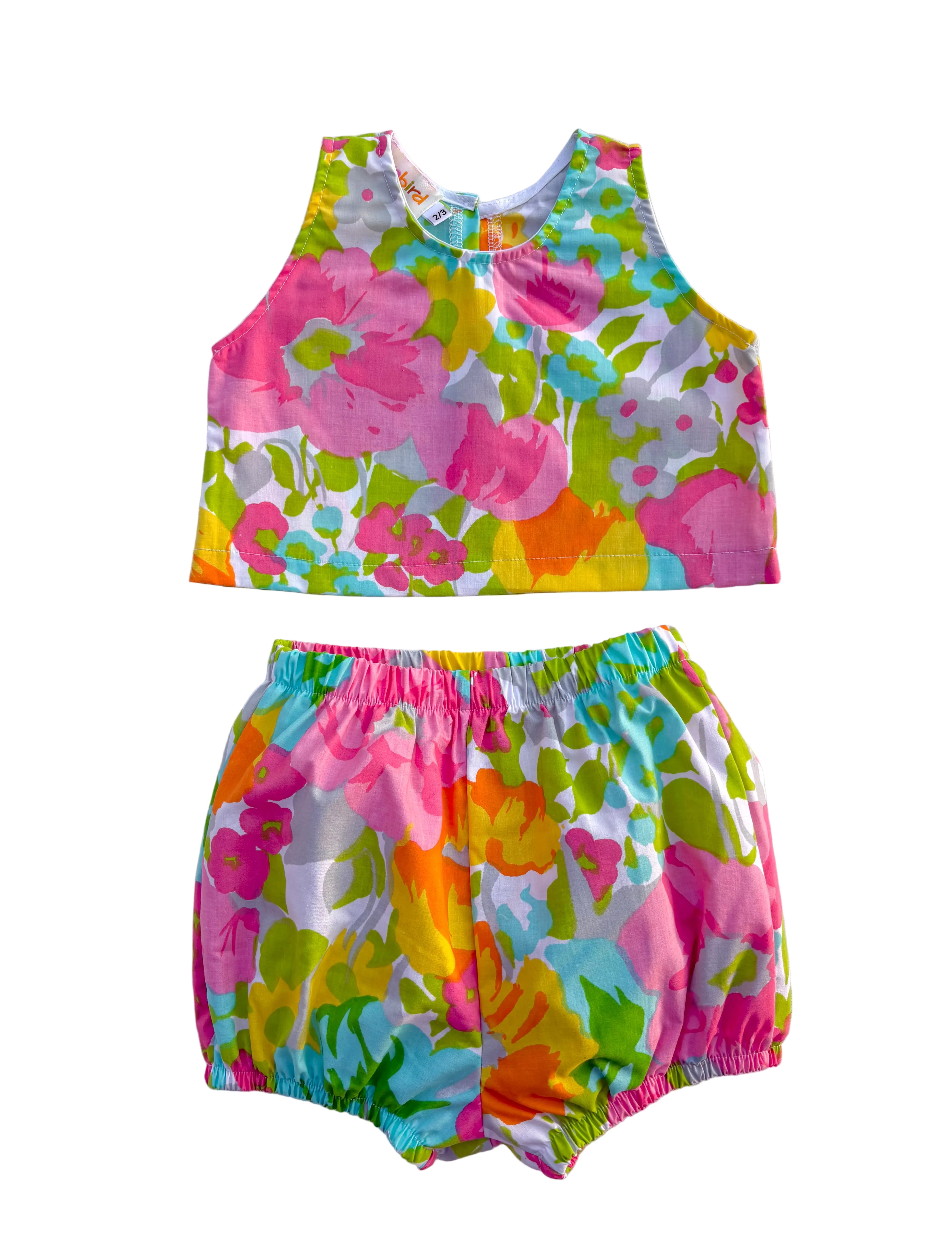 Colorful girls floral top and shorts set on a white background