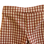 Close-up of brown and white checkered toddler bell bottoms 