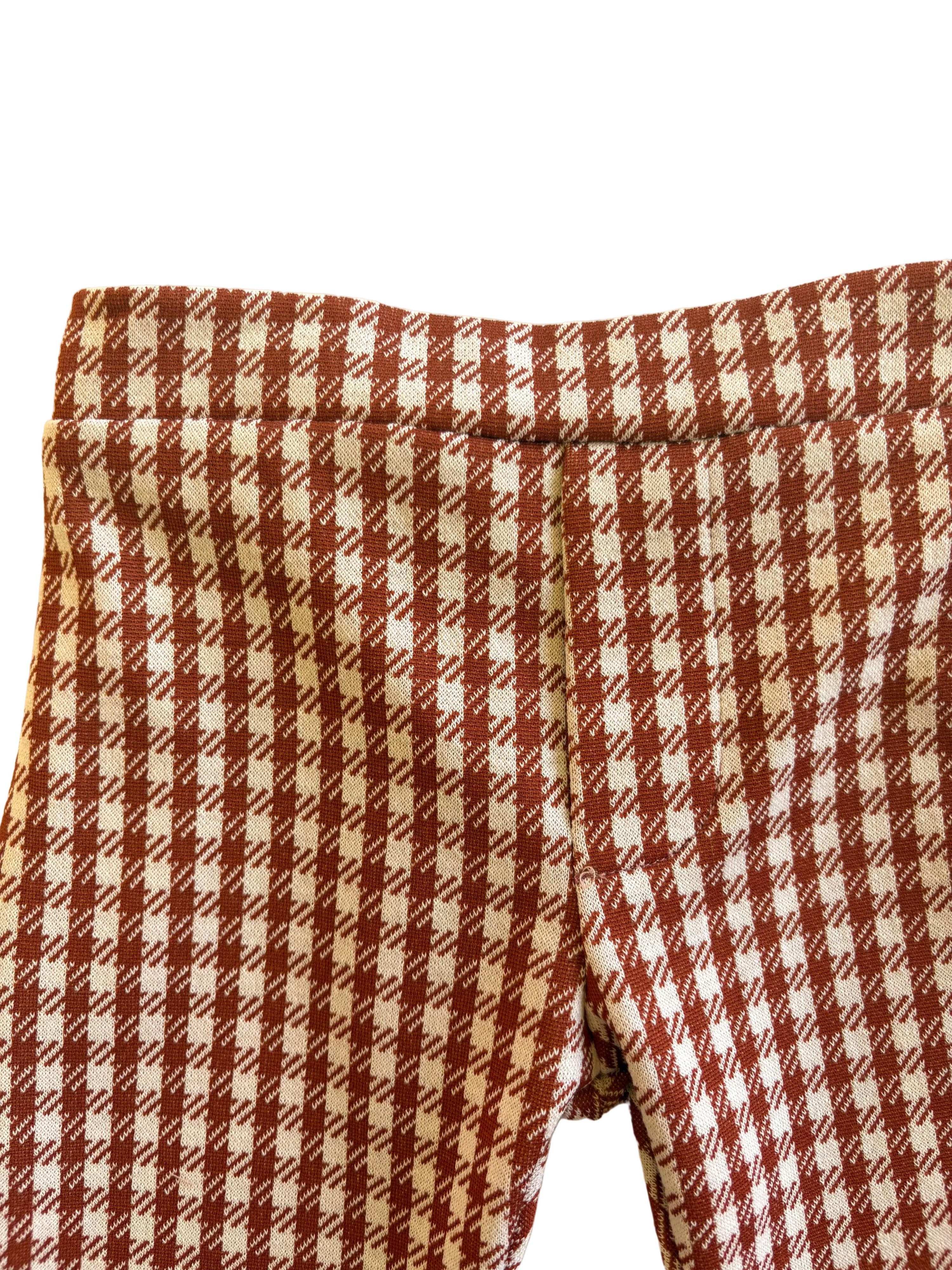 Close-up of brown and white checkered toddler bell bottoms 