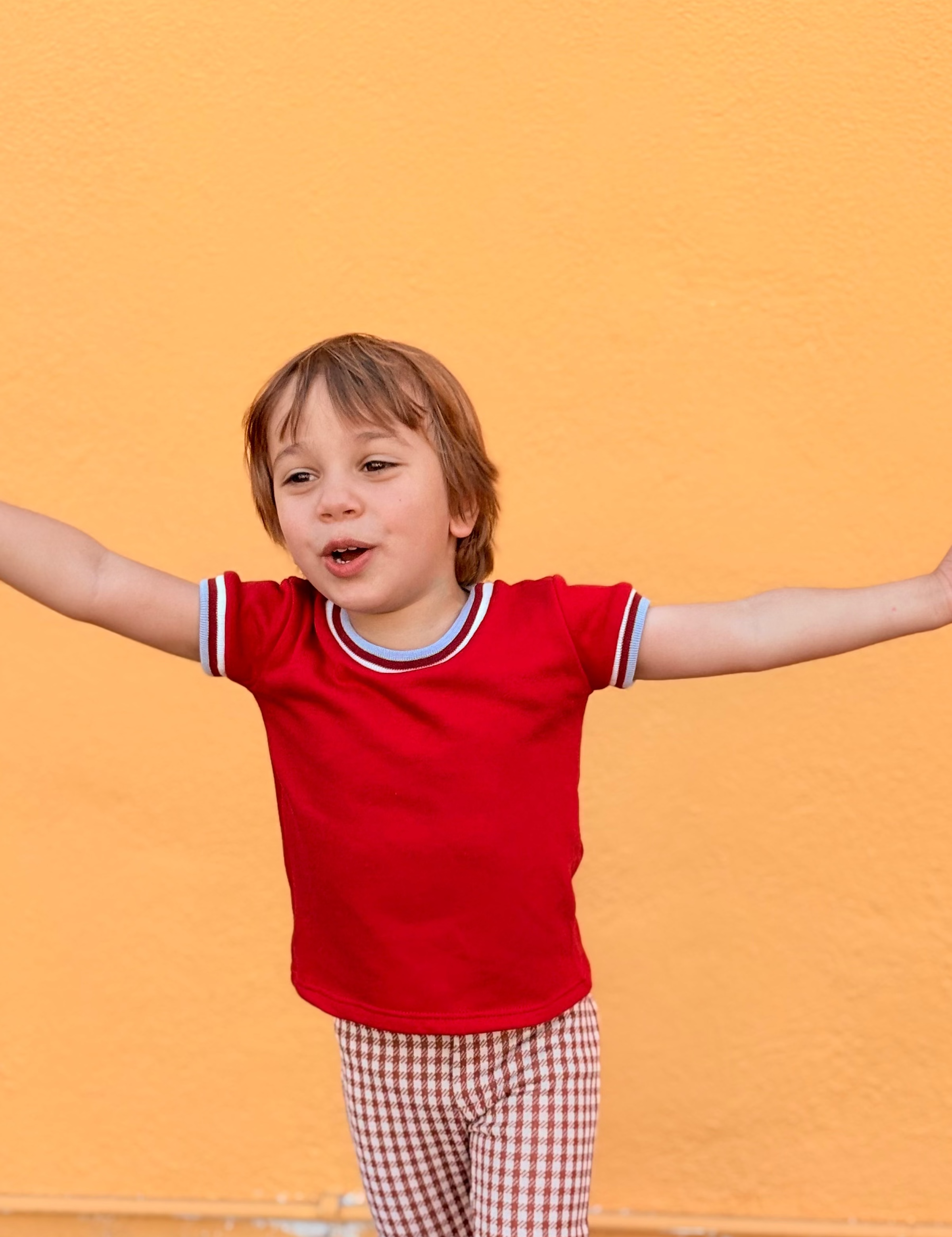 toddler boy wearing cool retro funky red shirt with trim