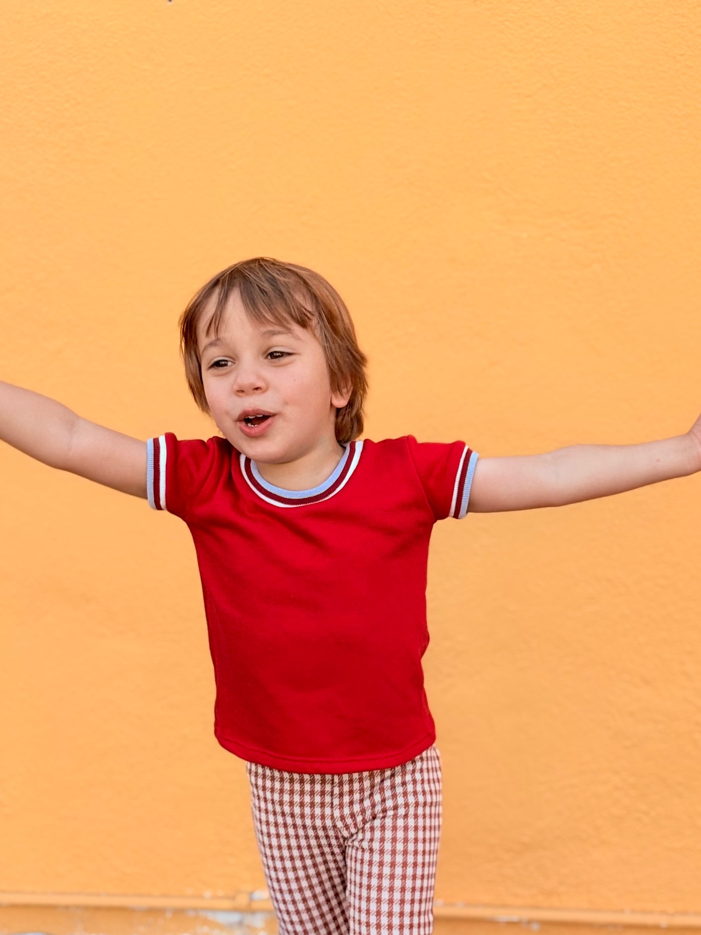 toddler boy wearing cool retro funky red shirt with trim