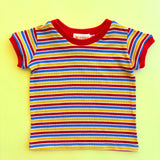 Colorful kids striped shirt with red trim on a yellow background