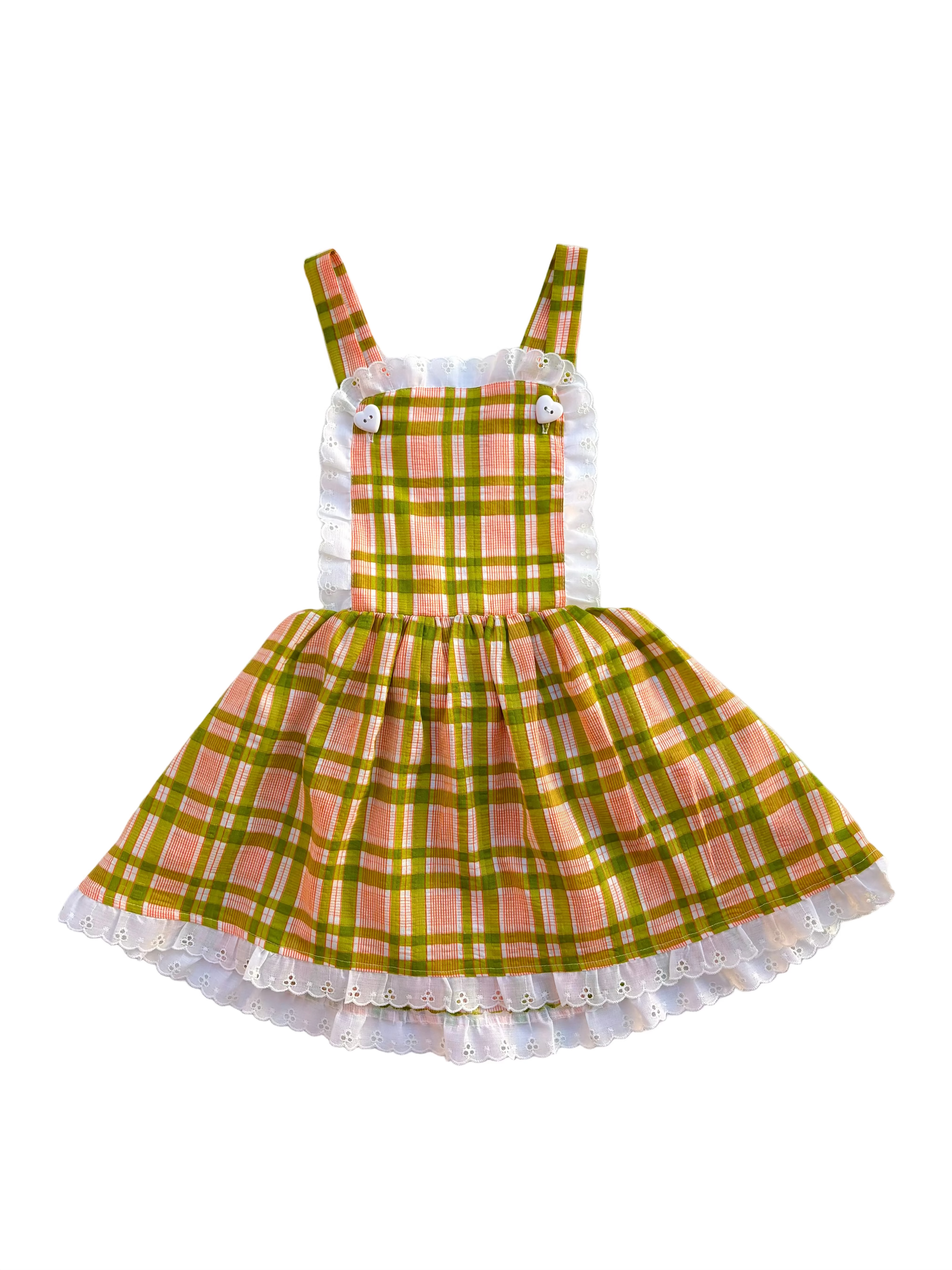Green and pink plaid girls pinafore dress with white lace trim on a white background