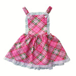 Pink plaid dress with white lace trim on a white background