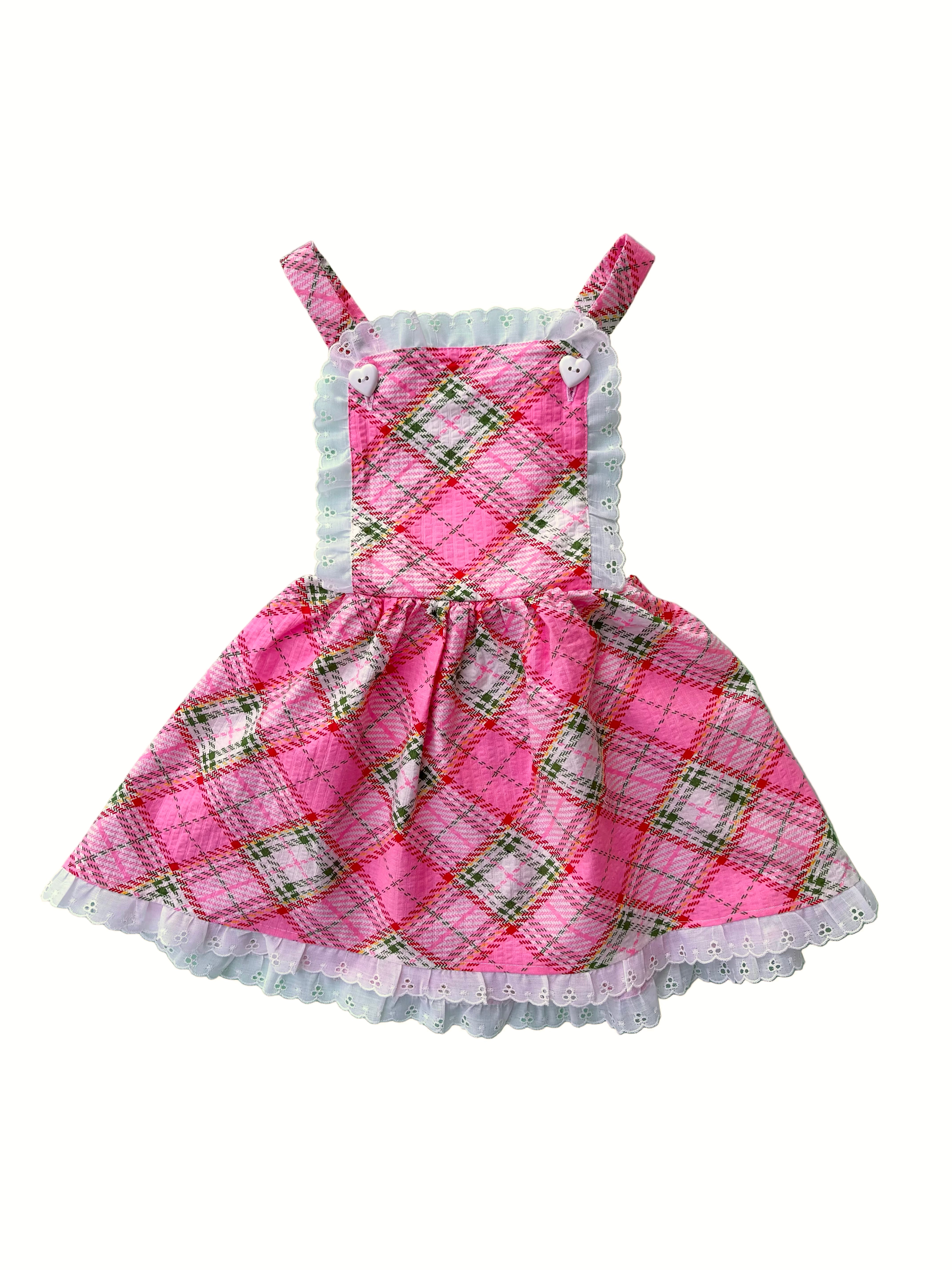 Pink plaid dress with white lace trim on a white background